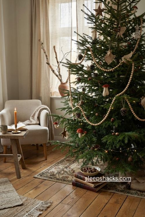 woodsy christmas tree with warm wooden bead garland pinecones and cozy lights 