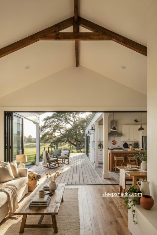 wraparound porch barndominium floor plan with open living room and wide glass doors 